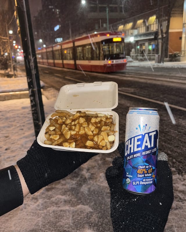 Toronto late-night poutine in a takeaway container held in a gloved hand, snow falling, streetcar lights behind